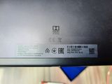 the back of a black laptop with a sticker on it