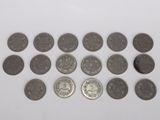 a close up of a bunch of coins on a white surface