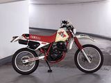 a red and white motorcycle parked in a parking garage