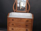 a small dresser with a mirror on top of it