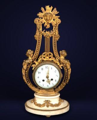 an image of a gold and white clock on a stand