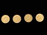 four different types of gold coins in a row on a black background
