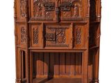 an image of a wooden cabinet with carvings on top of it
