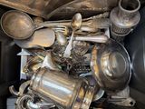 a pile of old silverware in a black box