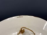 a white plate with a small piece of food in it