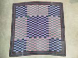 an image of a checkered blanket laying on the floor