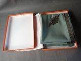 a box that has a green and orange scarf inside of it