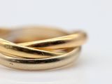 a close up of a gold ring on a white surface