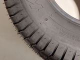a close up of a tire on a white surface