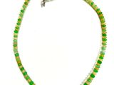 green and white beaded necklace on a white background