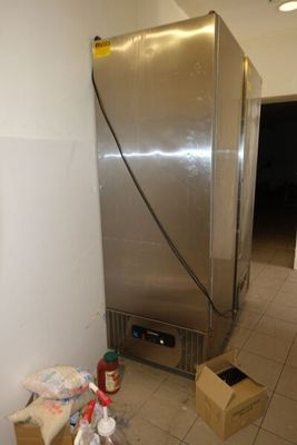 une photo d'un réfrigérateur dans une pièce où se trouvent de nombreux cartons