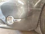 a close up of a car ' s front bumper and tire