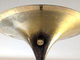 a brass plate with a horn on top of it