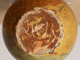 a close up of a vase with writing on it