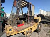 a fork truck that is parked in the dirt