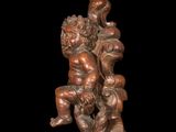 an image of a statue of two children sitting on a tree stump