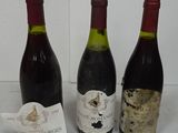three bottles of wine sitting next to each other on a table