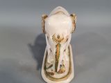 a figurine of an elephant with a crown on it ' s head