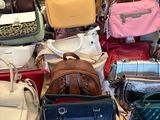 a lot of purses that are sitting on a table
