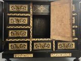 an image of a black and gold chest of drawers with a door open