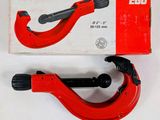 a close up of a pair of red pipe cutters on a white surface