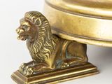 a statue of a lion that is sitting on top of a table