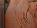 carvings of a woman holding a baby in her arms on a wooden panel