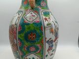 a vase with a handle on it sitting on a table