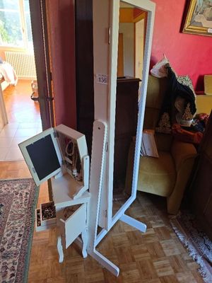 a computer on a stand in the middle of a living room