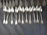 a lot of spoons that are lined up on a table