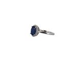 an oval sapphire and diamond ring on a white background