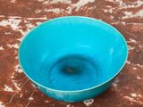 a blue bowl that is sitting on a table