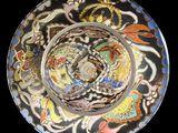 a black plate with a multicolored design on it