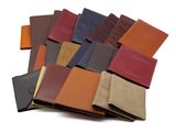 plusieurs portefeuilles en cuir de différentes couleurs empilés les uns sur les autres