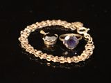 a necklace and a ring on a black surface