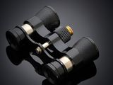 a pair of binoculars on a black background with a reflection