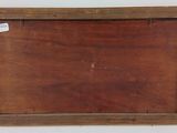 an old wooden picture frame with a label on it