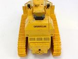 a yellow toy tank that is sitting on a white surface