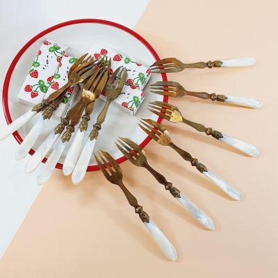 a lot of forks and spoons on a plate