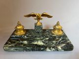 an image of a marble desk with a golden eagle on top of it