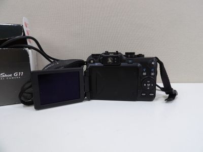 two cameras sitting next to each other on top of a table