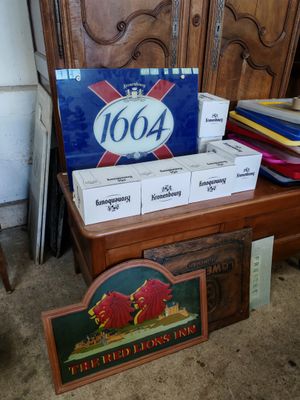 boxes of beer sit on a table in front of a wooden chair