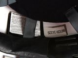 a black bag with a label on it sitting on a table
