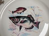 a plate with a picture of a fish and a fish on it