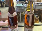 two bottles of wine that are sitting on a table