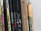 many books that are stacked on top of each other