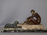 statue of a woman sitting on a marble base with a dog