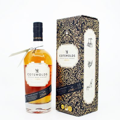 the bottle of cotswolds is next to a cardboard box