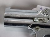 a gun that is sitting on top of a piece of paper