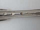 a close up of a spoon and fork on a table